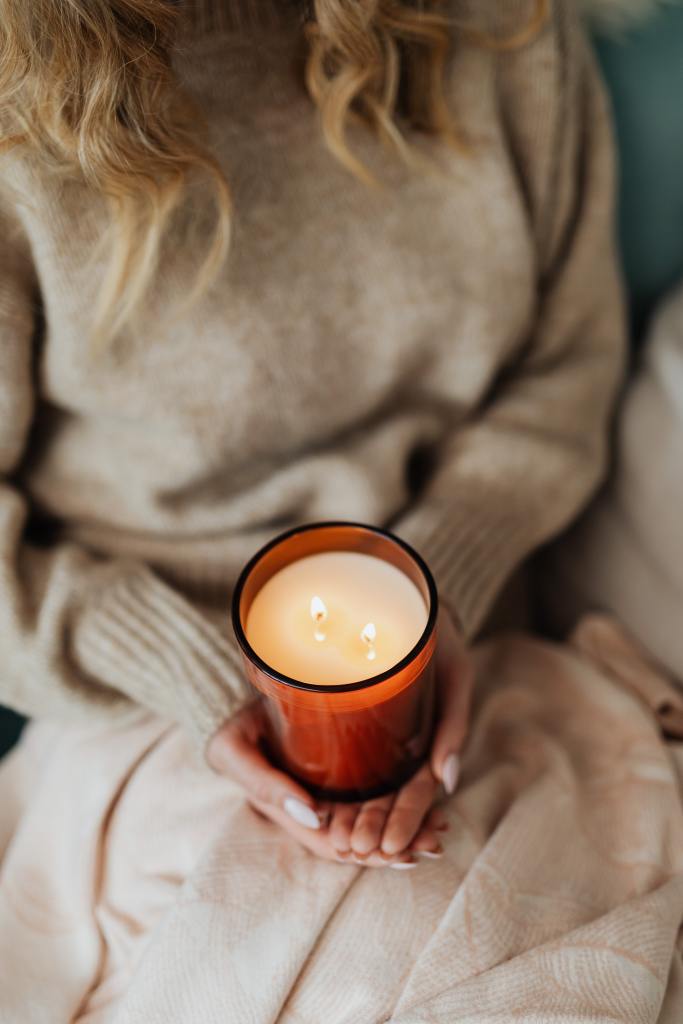 Products to help with depression. Woman with blanket and candle